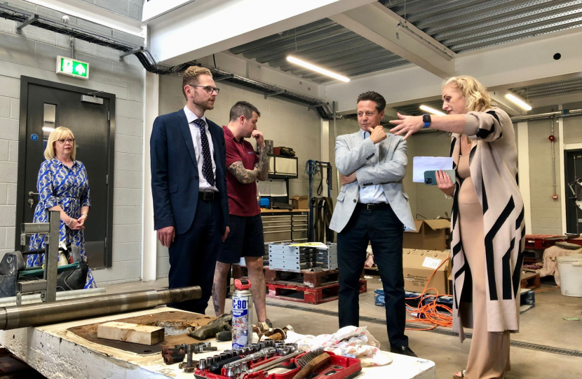 A bed of tools lays beneath Jack, Hannah and Minister Huddleston