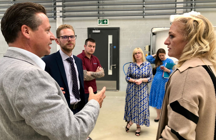 Minister Huddleston, Jack and Hannah speak together in a close group