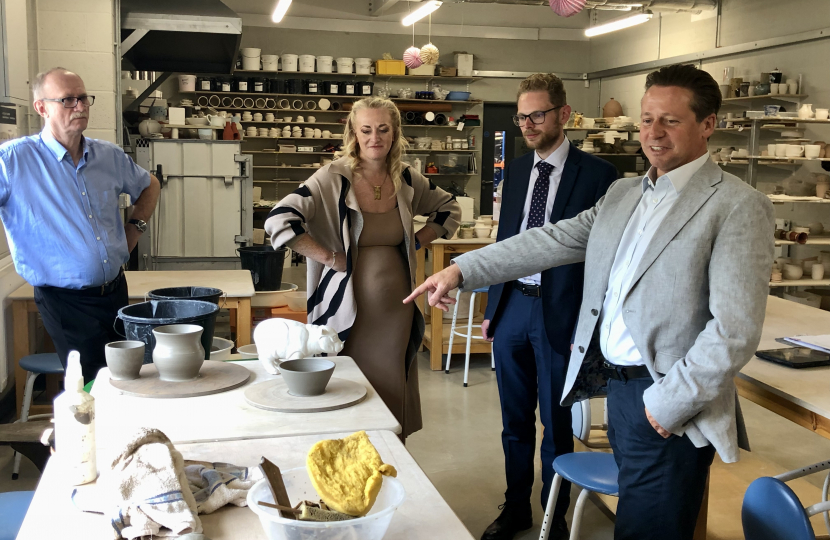 Jack and Minister Huddleston being shown recently made pottery