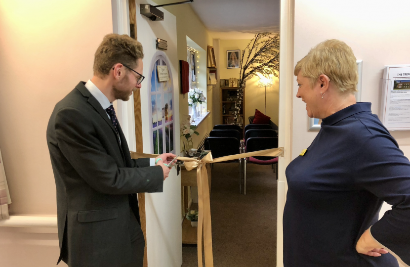 Jack cuts the ribbon near the door